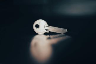 a close up of a key on a table by rc.xyz NFT gallery courtesy of Unsplash.