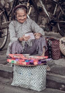 woman sitting near bike by Nam Hoang courtesy of Unsplash.